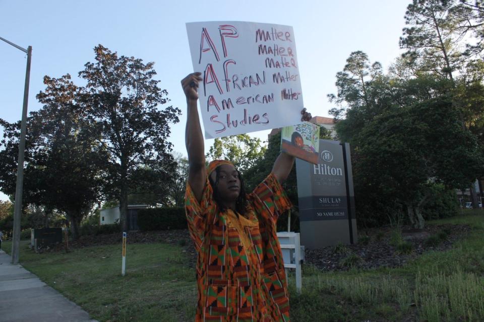 Amere Wofford holds up a sign at the intersection of SW 34th Street and Hull Road in Gainesville during a rally to protest what some consider to be recent attacks on Black Studies by Florida Gov. Ron DeSantis.
(Photo: Photo by Voleer Thomas/For The Guardian)
