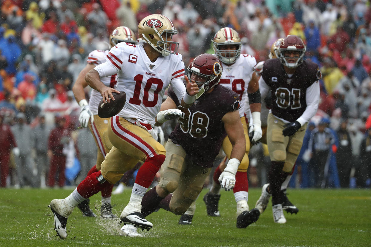 San Francisco 49ers quarterback Jimmy Garoppolo (10) looks for a receiver as he is pressured by Washington Redskins defensive end Matthew Ioannidis in the first half of an NFL football game, Sunday, Oct. 20, 2019, in Landover, Md. (AP Photo/Alex Brandon)