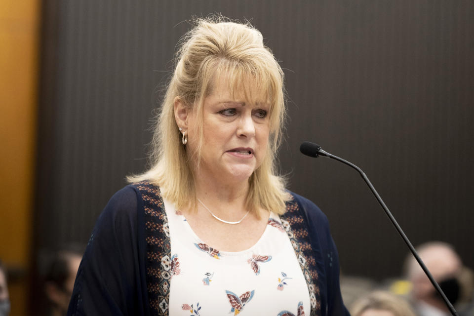 Elizabeth Hupp, daughter of Claude Snelling, makes a statement as Joseph James DeAngelo is in the courtroom during the third day of victim impact statements at the Gordon D. Schaber Sacramento County Courthouse on Thursday, Aug. 20, 2020, in Sacramento, Calif. DeAngelo shot Hupp's father Snelling in Visalia, Calif., in 1975. Snelling died thwarting DeAngelo's attempted kidnapping of his 16-year-old daughter, Elizabeth Hupp. DeAngelo, 74, a former police officer in California eluded capture for four decades before being identified as the Golden State Killer. (Santiago Mejia/San Francisco Chronicle via AP, Pool)