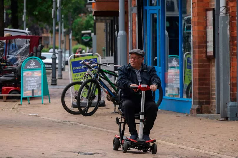 Sutton-in-Ashfield's town centre, with an elderly man riding a mobility scooter through town