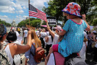 <p>A child raises her hand in protest as she and her mother join demonstrators to rally and march calling for “an end to family detention” and in opposition to the immigration policies of the Trump administration in Washington, D.C., June 28, 2018. (Photo: Jonathan Ernst/Reuters) </p>