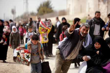 A man gestures as they flee the rebel-held town of Hammouriyeh, in the village of Beit Sawa, eastern Ghouta, Syria March 15, 2018. REUTERS/Omar Sanadiki