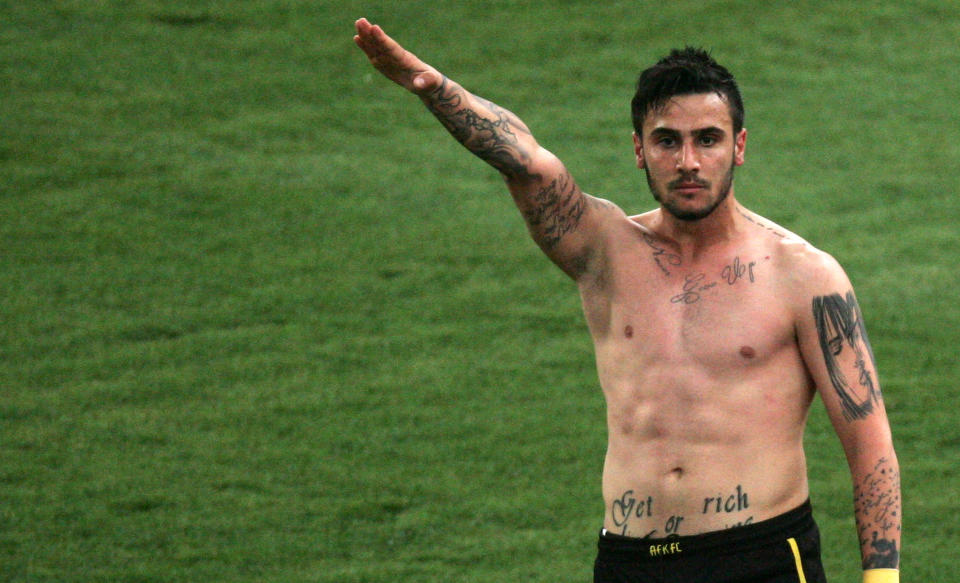 AEK Athens midfielder Giorgos Katidis raises his hand in a Nazi style salute as he celebrates scoring the winner in a Greek league gaame against Veria in Athens' Olympic Stadium, Saturday, March 16, 2013. (AP Photo/INTIME)