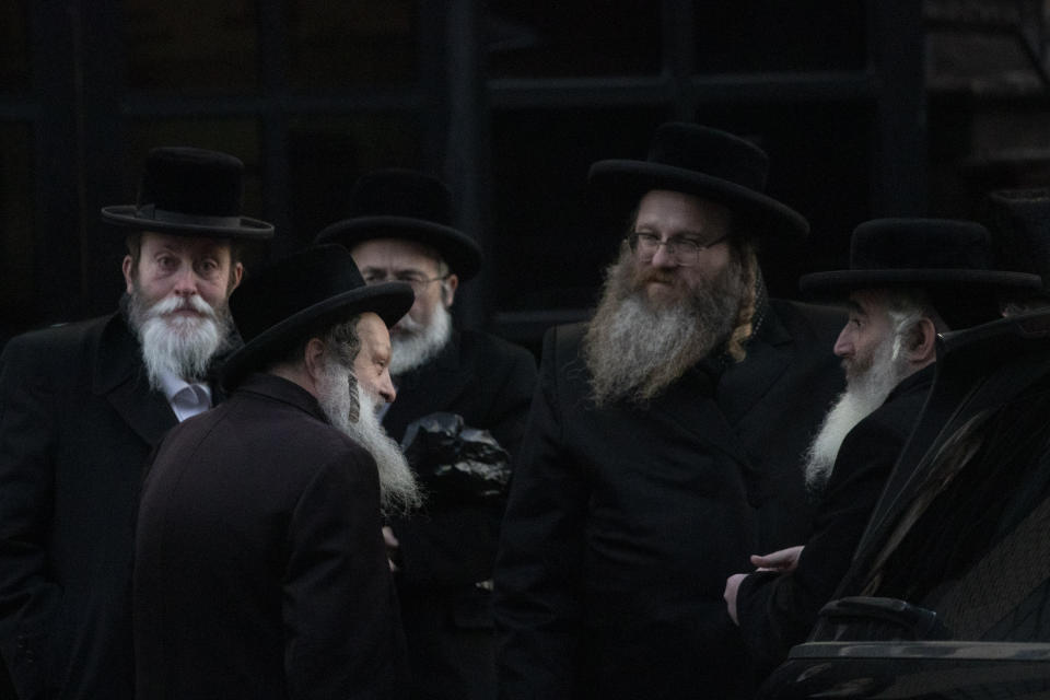 Orthodox Jewish men gather outside a Brooklyn synagogue prior to a funeral for Mosche Deutsch, Wednesday, Dec. 11, 2019 in New York. Deutsch, a rabbinical student from Brooklyn, was killed Tuesday in the shooting inside a Jersey City, N.J. market. (AP Photo/Mark Lennihan)