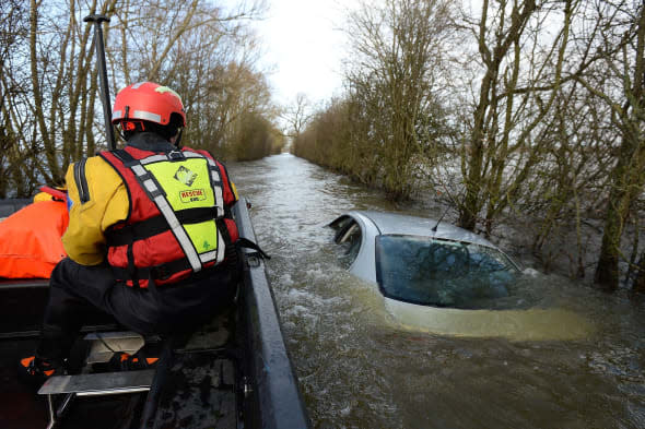 File photo dated 26/01/14 of members of the Avon and Somerset Police Underwater Search Unit inspecting a submerged abandoned car as they head to the village of Muchelney in Somerset, the car owned by Mr Zajaczkowski  has been sold for more than 100,000 pounds on Ebay. PRESS ASSOCIATION Photo. Issue date: Thursday March 20, 2014. The unnamed bidder paid ?101,100 on the online auction site to buy the Seat Toledo after it was put up for sale by owner Hubert Zajaczkowski, 21. Mr Zajaczkowski is donating the cash to a charity helping the victims of flooding in Somerset. See PA story ENVIRONMENT Floods Car. Photo credit should read: Andrew Matthews/PA Wire