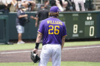East Carolina pitcher Gavin Williams (26) waits as umpires, background, review a play at the plate during the eighth inning of an NCAA college baseball super regional game against Vanderbilt, Friday, June 11, 2021, in Nashville, Tenn. The call was reversed and Vanderbilt's run counted. Vanderbilt won 2-0. (AP Photo/Mark Humphrey)