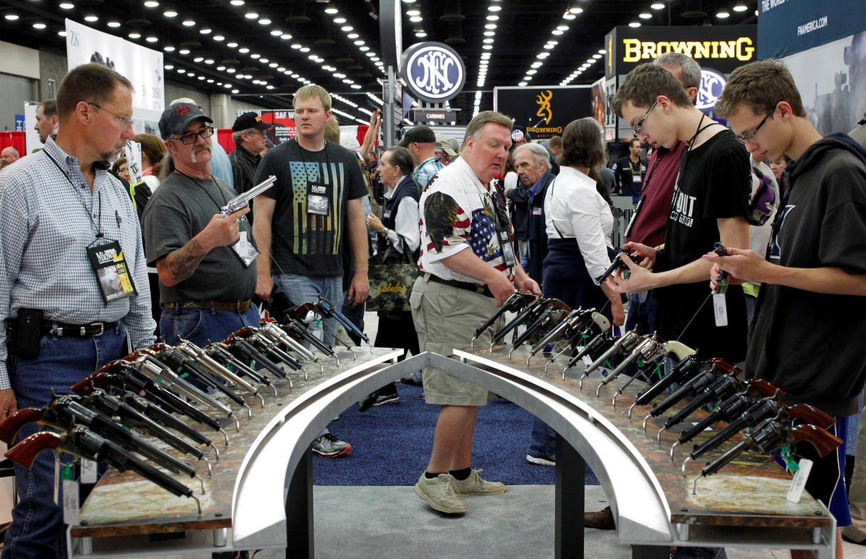 Gun enthusiasts look over Benelli USA guns at a National Rifle Association show in Louisville, Kentucky, May 21, 2016. (Photo: John Sommers II / Reuters)