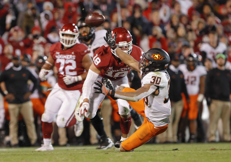 Oklahoma linebacker Curtis Bolton (18) breaks up a pass intended for Oklahoma State running back Chuba Hubbard (30) in the second half of an NCAA college football game in Norman, Okla., Saturday, Nov. 10, 2018. Oklahoma won 48-47. (AP Photo/Alonzo Adams)