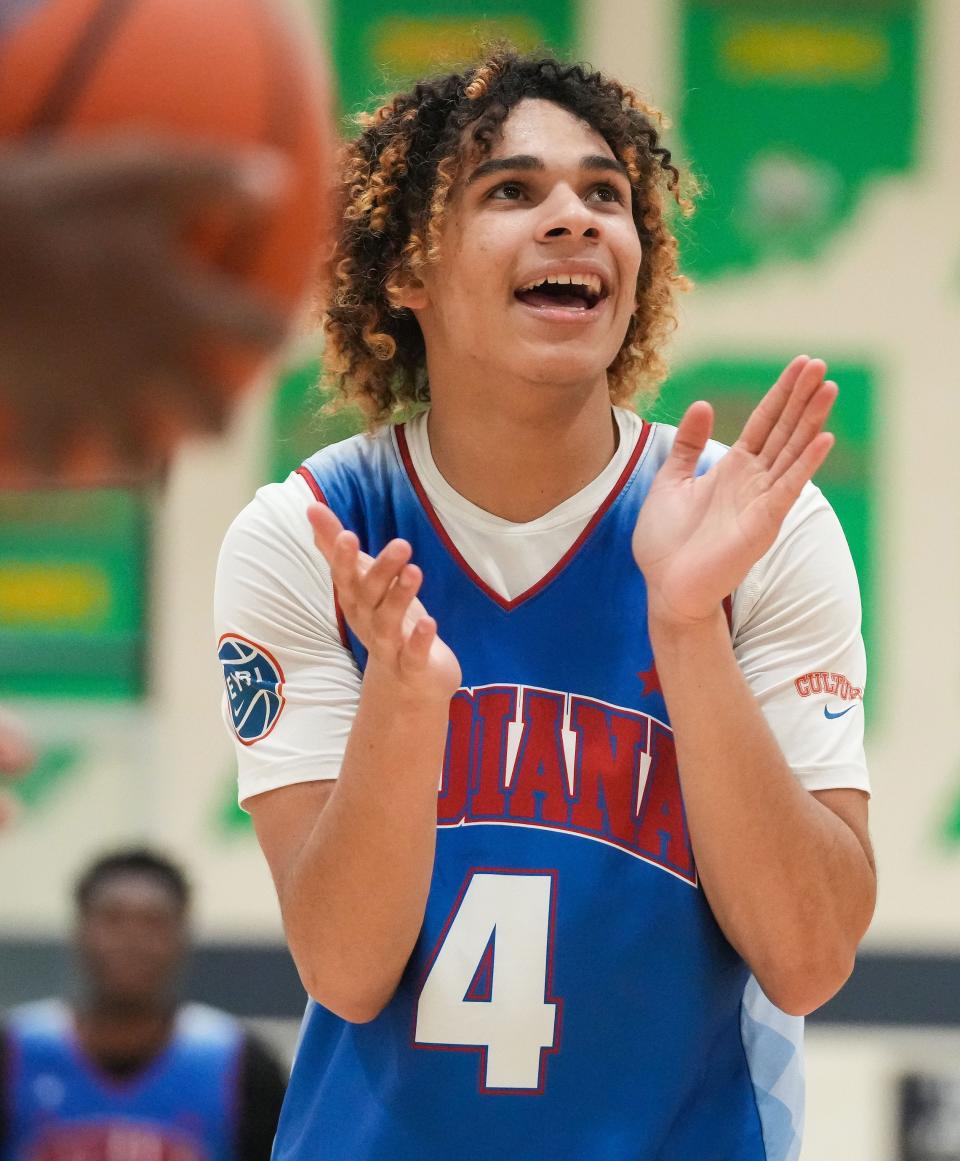 All-Star Junior Micah Davis (4) claps his hands in excitement Wednesday, June 7, 2023, during the Indiana All-Stars vs. Juniors boys game at Cathedral High School in Indianapolis. 