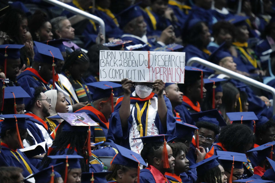 A graduate holds a sign as President Joe Biden speaks at Howard University's commencement in Washington, Saturday, May 13, 2023. (AP Photo/Alex Brandon)