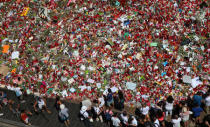 People gather at an impromptu memorial where a van crashed into pedestrians at Las Ramblas in Barcelona, Spain, August 22, 2017. REUTERS/Albert Gea