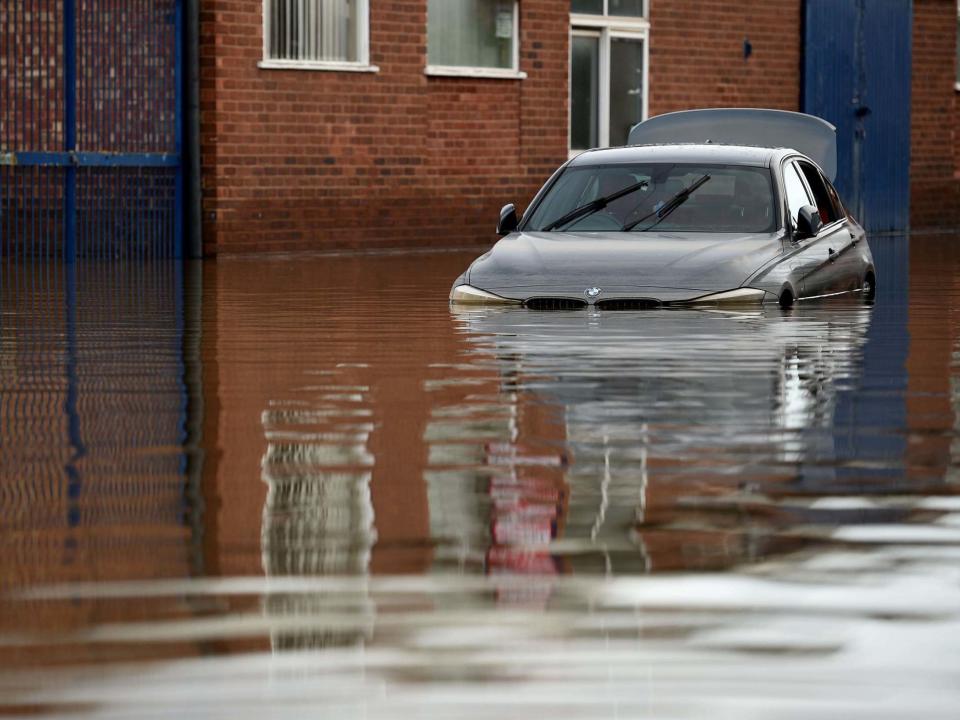 A car is partially submerged in flood waters in Shrewsbury, Shropshire, 26 February 2020: Oli Scarff/AFP via Getty Images