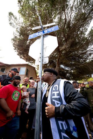 <p>Phil Emerson</p> E-40 kisses the street pole for the recently renamed E-40 way in Vallejo, California