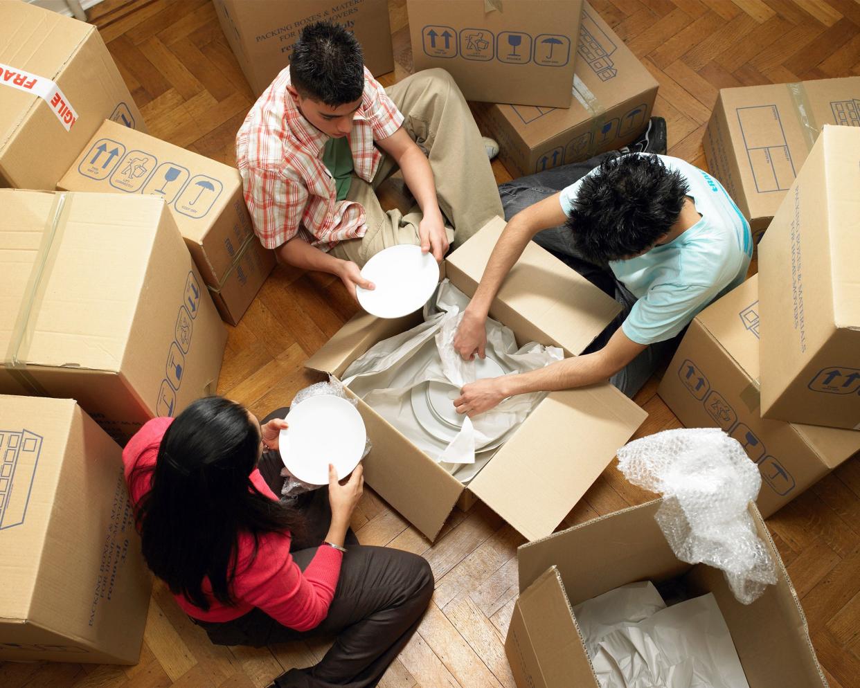 family unpacking cardboard boxes