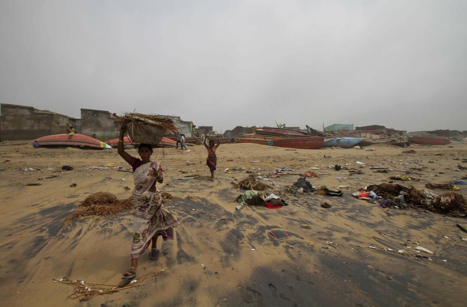 Locals clean up damage made by Cyclone Fani in the Penthakata fishing village of Puri, in the eastern Indian state of Orissa, Saturday, May 4, 2019. A mammoth preparation exercise that included the evacuation of more than 1 million people appears to have spared India a devastating death toll from one of the biggest storms in decades, though the full extent of the damage was yet to be known, officials said Saturday. (AP Photo)