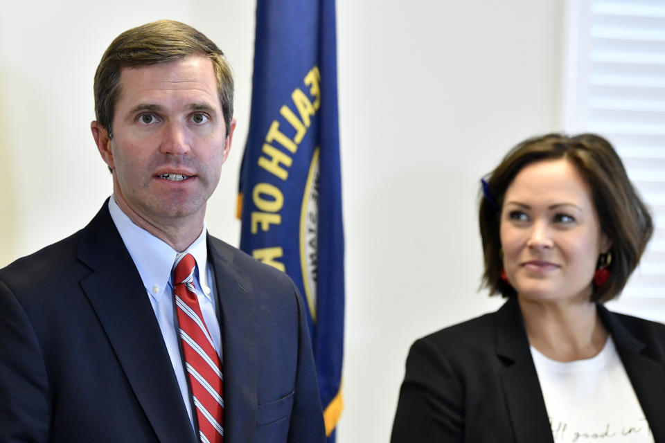 Kentucky Governor-Elect Andy Beshear, left, and his Lt. Governor Jacqueline Coleman speak with reporters following the concession of incumbent Governor Matt Bevin in Frankfort, Ky., Thursday, Nov. 14, 2019. In a recanvass, Beshear defeated Bevin by 5136 votes. (AP Photo/Timothy D. Easley)