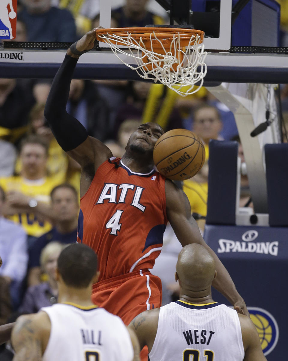 Atlanta Hawks' Paul Millsap (4) dunks as Indiana Pacers' David West (21) watches during the second half in Game 5 of an opening-round NBA basketball playoff series Monday, April 28, 2014, in Indianapolis. Atlanta defeated Indiana 107-97. (AP Photo/Darron Cummings)