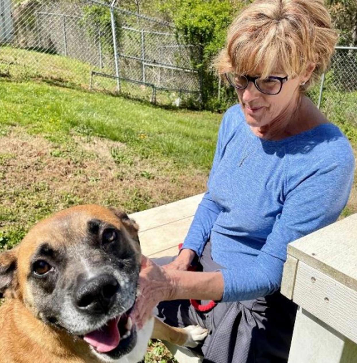 Adoption Coordinator Heather Dover spends time with Molly, a 7-year-old Boxer Mix