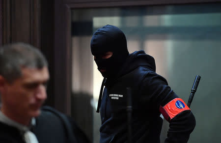 A masked Belgian police officer is seen during the trial of Mehdi Nemmouche and Nacer Bendrer, who are suspected of killing four people in a shooting at Brussels' Jewish Museum in 2014, at Brussels' Palace of Justice, Belgium January 15, 2019. Emmanuel Dunand/Pool via REUTERS