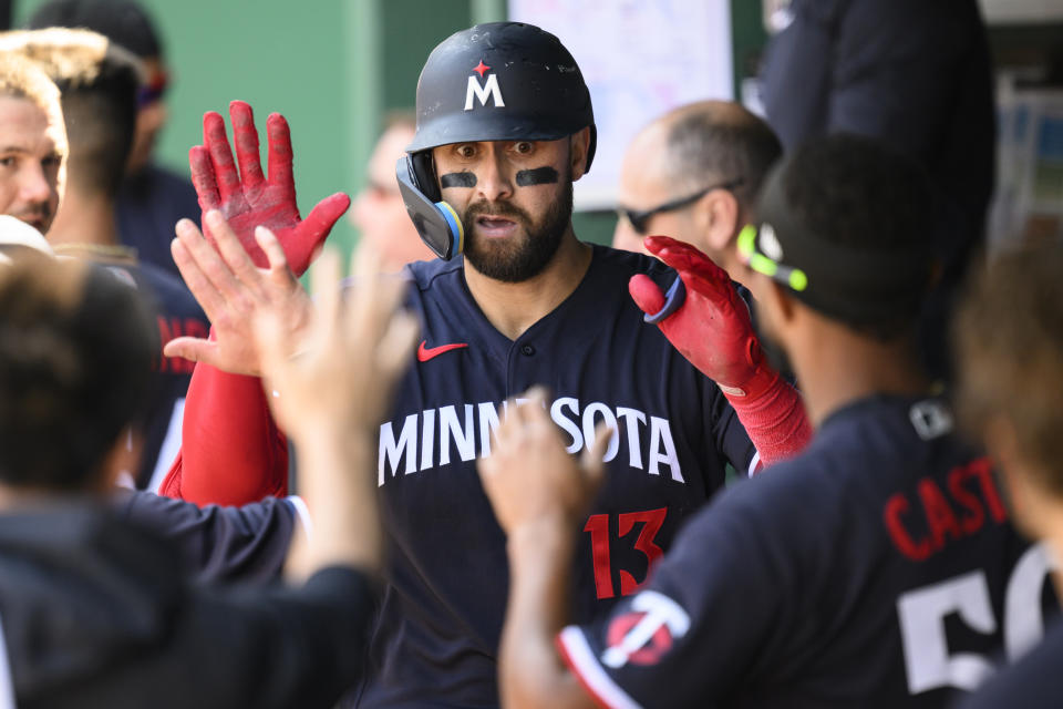 The Minnesota Twins' Joey Gallo (13) is congratulated after hitting a home run during the sixth inning of a baseball game against the Kansas City Royals, Sunday, April 2, 2023, in Kansas City, Mo. (AP Photo/Reed Hoffmann)