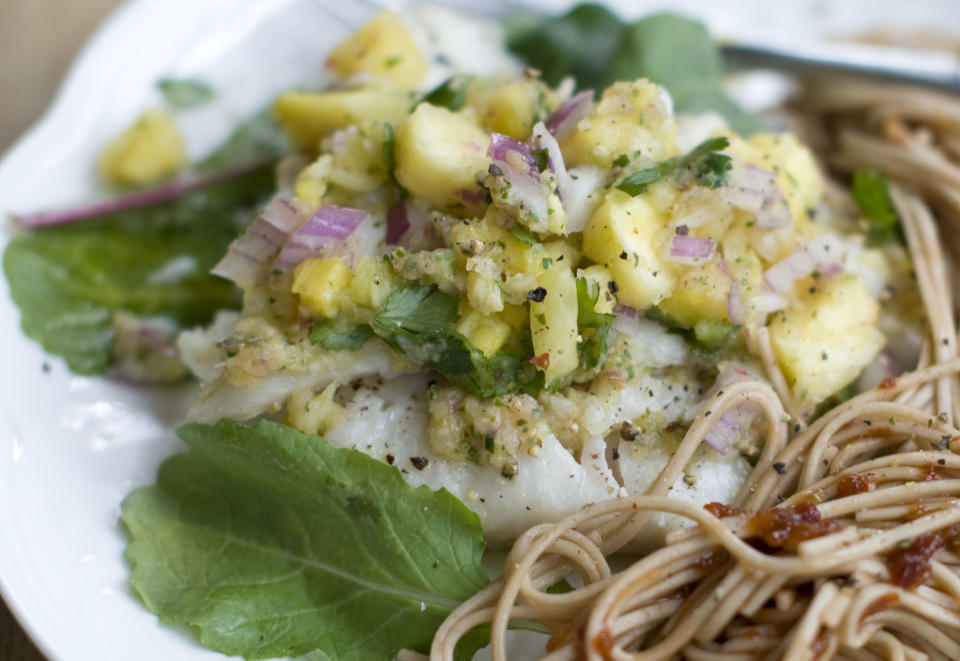 This Dec. 2, 2013, photo shows baked haddock with pineapple mint salsa in Concord, N.H. Baked white fish is a fast and healthy way to get dinner on the table. The secret to getting a good tasting baked white fish, without adding tons of fat and calories or rendering it a tasteless hunk of protein, is all in how you dress it. (AP Photo/Matthew Mead)