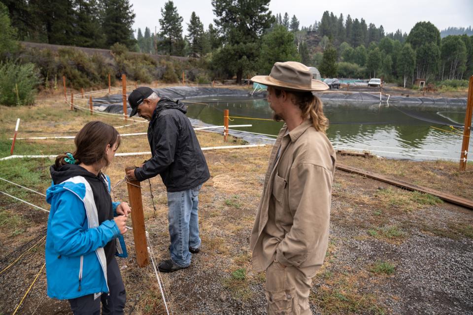 Klamath River Tribes' Ambodat Aquaculturist Carlie Sharpes (left), Hatchery Maintenance Manager James Esqueda (center) and Fishery Technician Noah Nicholson (right) perform work duties at the hatchery in Chiloquin, Oregon, on Aug. 22, 2023.