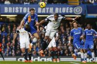 Branislav Ivanovic (L) of Chelsea and Ashley Williams of Swansea jump for the ball during their English Premier League soccer match at Stamford Bridge, London, December 26, 2013. REUTERS/Andrew Winning