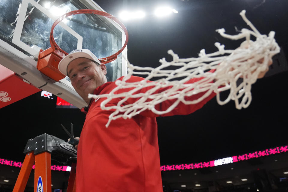 Ohio State coach Kevin McGuff waves the net as he celebrates the team's win over Michigan in an NCAA college basketball game to claim the regular-season Big Ten title, Wednesday, Feb. 28, 2024, in Columbus, Ohio. (AP Photo/Sue Ogrocki)