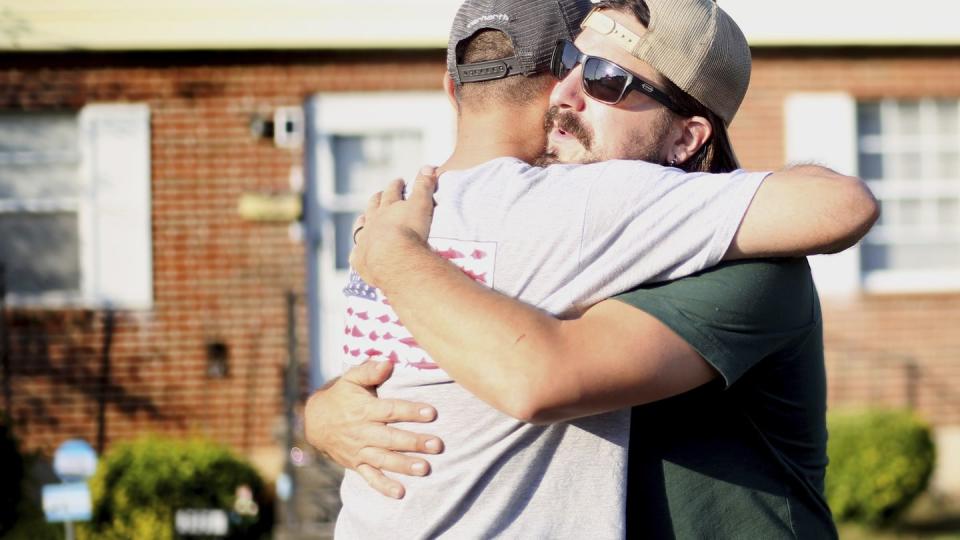 Tashmorad Qara, left, and Andreas Panagore share a moment after catching up over a traditional Afghan meal, prepared by Qara, on May, 17, 2023, in Roanoke, Va. (Heather Rousseau/The Roanoke Times via AP)