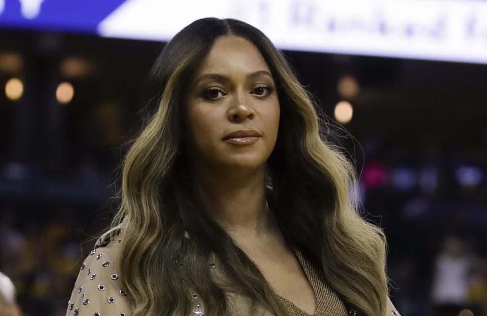 FILE - In this Wednesday, June 5, 2019, file photo, Beyonce walks to her seat during the first half of Game 3 of basketball's NBA Finals between the Golden State Warriors and the Toronto Raptors in Oakland, Calif. Beyoncé did not let Juneteenth 2020 pass without dropping one of her signature surprises in the form a new single called “Black Parade.” The singer's website says the song released late Friday, June 19, 2020, will benefit black-owned small businesses. (AP Photo/Ben Margot, File)