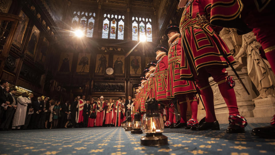 Yeoman Warders conduct the traditional ceremonial search in the Palace of Westminster during the start of the state opening of parliament in London, Thursday Dec. 19, 2019. Queen Elizabeth II will formally open a new session of Britain’s Parliament, with a speech giving the first concrete details of what Prime Minister Boris Johnson plans to do with his commanding new majority. (Richard Pohle, Pool via AP)