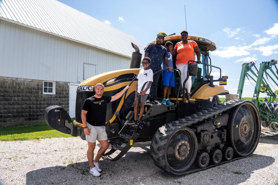 From right: Tina Gunn poses for a photo with her sons, Makai, Orlando and Tj, and Zach Twedt at the Twedt family farm in rural Story City.