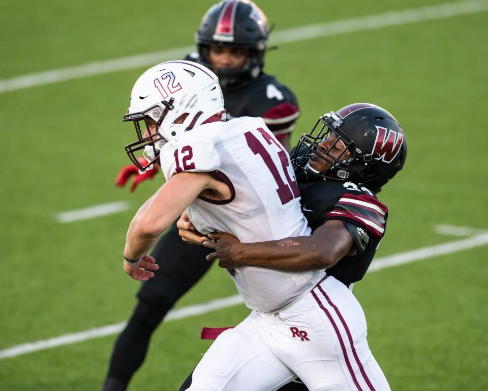 Weiss defender Samuel Miller tackles Round Rock quarterback Mason Cochran during the teams' season-opening game Friday. Miller totaled 20 tackles in the matchup.