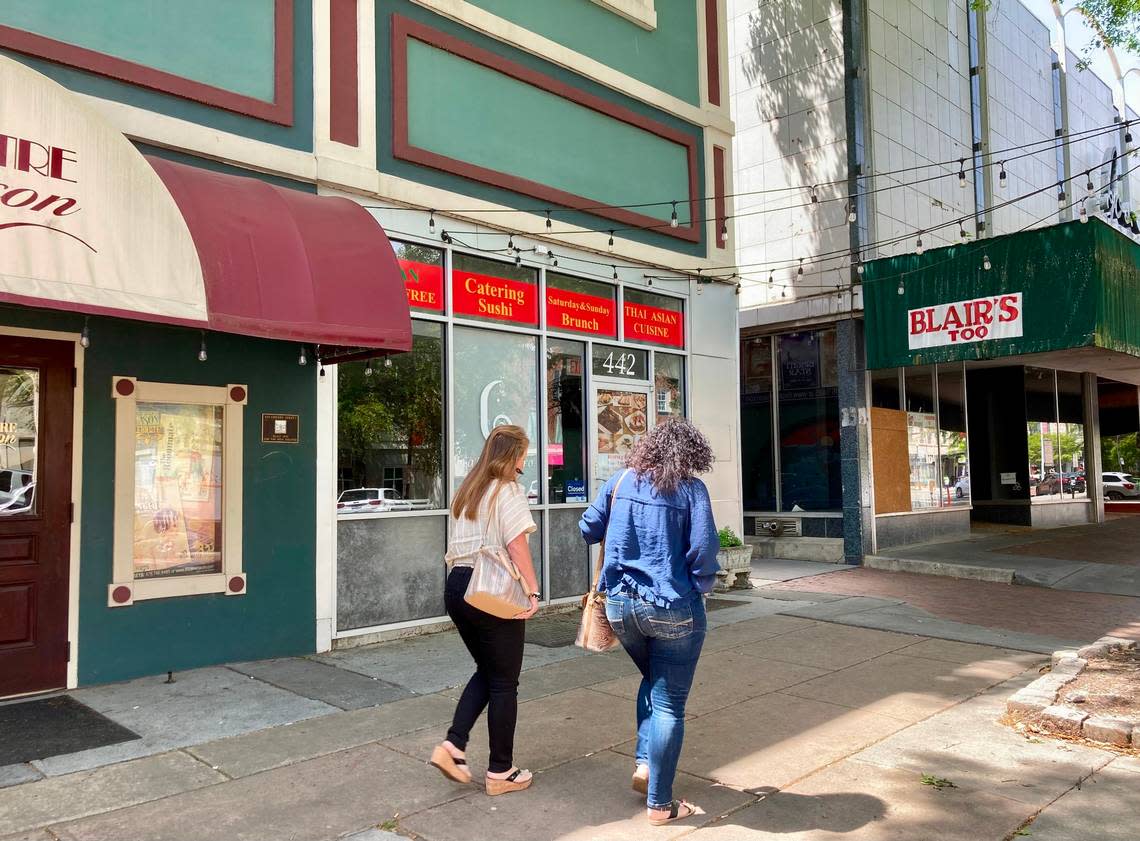 People walk by Ladda Bistro at 442 Cherry St. in downtown Macon.