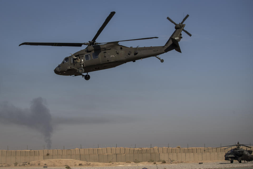 A helicopter takes off from a US military base at an undisclosed location in eastern Syria, Monday, Nov. 11, 2019. The deployment of the mechanized force comes after US troops withdrew from northeastern Syria, making way for a Turkish offensive that began last month. (AP Photo/Darko Bandic)