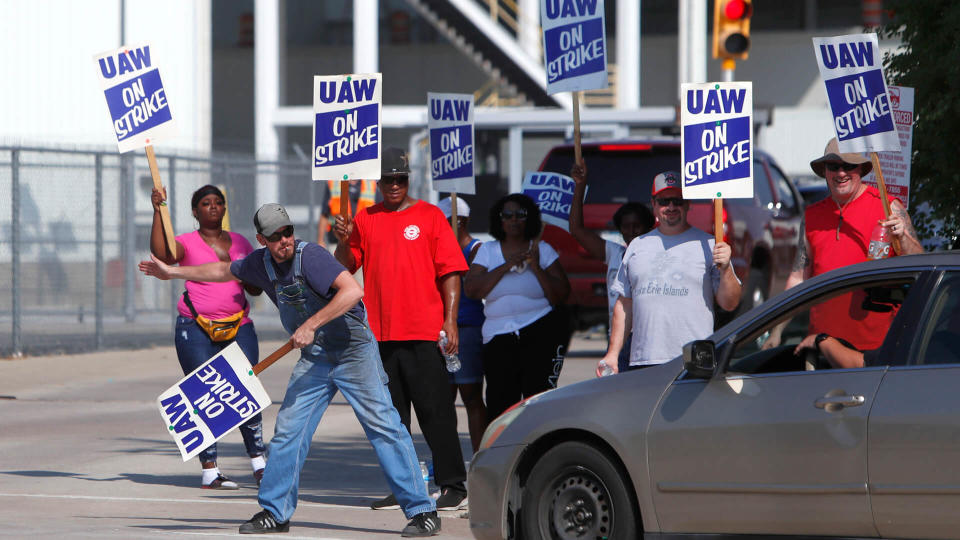 Mandatory Credit: Photo by LM Otero/AP/Shutterstock (10415460b)Gary Allison, left, waves while standing with other union members picketing outside the General Motors Plant in Arlington, Texas, .