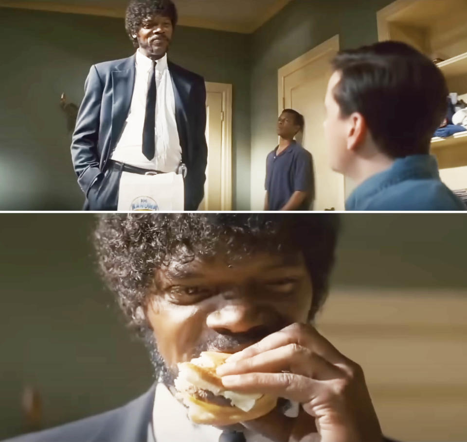 Jules Winnfield from "Pulp Fiction" stands in a kitchen with a bitten burger, tension between him and another character