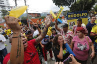 Supporters of Rodolfo Hernandez, presidential candidate with the Anti-corruption Governors League, celebrate as they listen to favorable partial results at his election night headquarters in Bucaramanga, Colombia, Sunday, May 29, 2022. (AP Photo/Mauricio Pinzon)