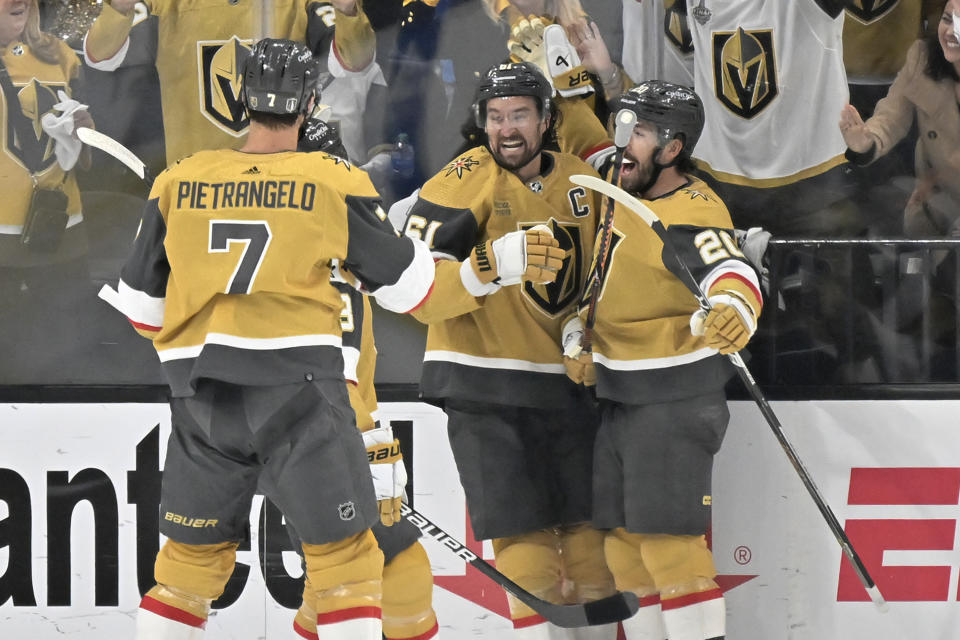 Vegas Golden Knights defenseman Alex Pietrangelo (7), right wing Mark Stone (61) and center Chandler Stephenson (20) celebrate Stephenson's goal against the Winnipeg Jets during the first period of Game 5 of an NHL hockey Stanley Cup first-round playoff series Thursday, April 27, 2023, in Las Vegas. (AP Photo/David Becker)