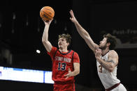 Stony Brook guard Dean Noll (13) shoots the ball against Charleston forward Ben Burnham during the first half of an NCAA college basketball game in the championship of the Coastal Athletic Association conference tournament, Tuesday, March 12, 2024, in Washington. (AP Photo/Terrance Williams)