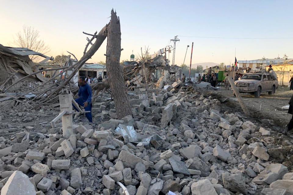 Afghan security members and people work at the site of a suicide attack in Zabul, Afghanistan, Thursday, Sept. 19, 2019. A powerful early morning suicide truck bomb devastated a hospital in southern Afghanistan on Thursday. (AP Photo/Ahmad Wali Sarhadi)