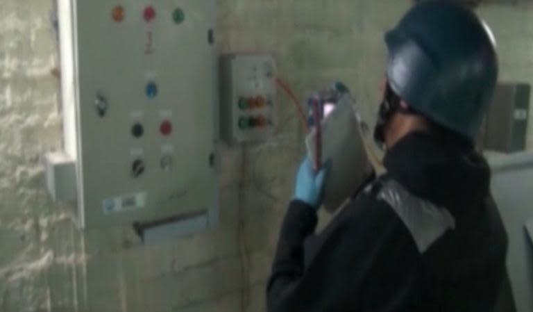 An image grab taken from Syrian television shows an inspector from the Organisation for the Prohibition of Chemical Weapons (OPCW) at an undisclosed location in Syria, on October 8, 2013