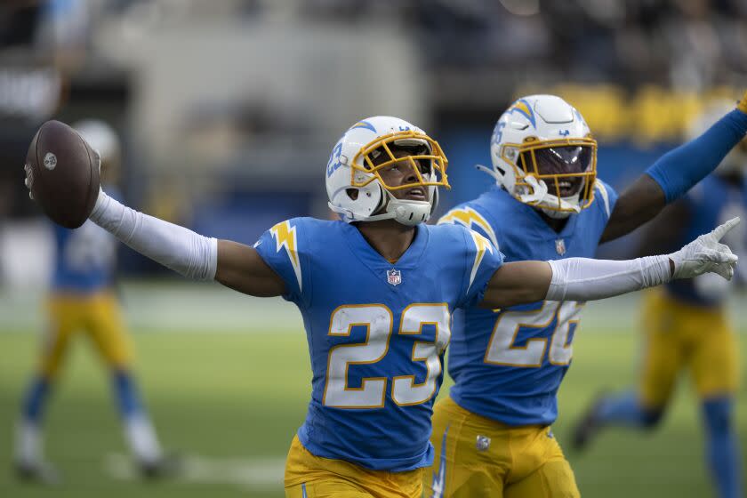 Los Angeles Chargers cornerback Bryce Callahan (23) and Asante Samuel Jr. (26) celebrate a turnover by the Las Vegas Raiders in the fourth quarter during an NFL football game Thursday, Sept. 8, 2021, in Inglewood, Calif. (AP Photo/John McCoy)