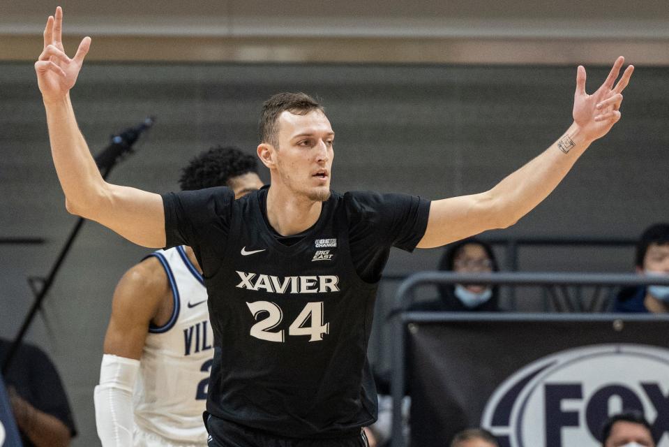 Xavier forward Jack Nunge (24) gestures after making a shot during the first half of the team's NCAA college basketball game against Villanova, Tuesday, Dec. 21, 2021, in Villanova, Pa.