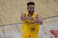 Golden State Warriors guard Stephen Curry celebrates after scoring during the first half of basketball's NBA All-Star Game in Atlanta, Sunday, March 7, 2021. (AP Photo/Brynn Anderson)