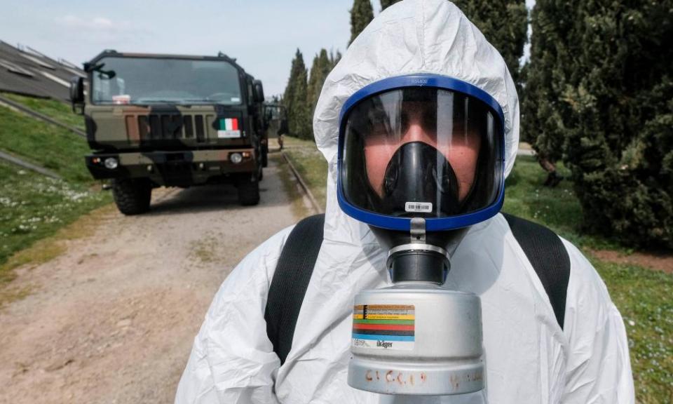 A soldier wearing a protective suit transporting coffins on military trucks from the Bergamo area to the Cinisello Balsamo cemetery at the start of the crisis.