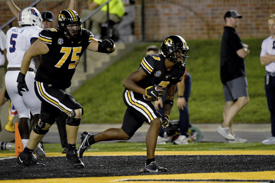 Missouri wide receiver Luther Burden III scores as teammate Mitchell Walters (75) watches during the first half of an NCAA college football game against Louisiana Tech Thursday, Sept. 1, in Columbia, Mo. (AP Photo/L.G. Patterson)