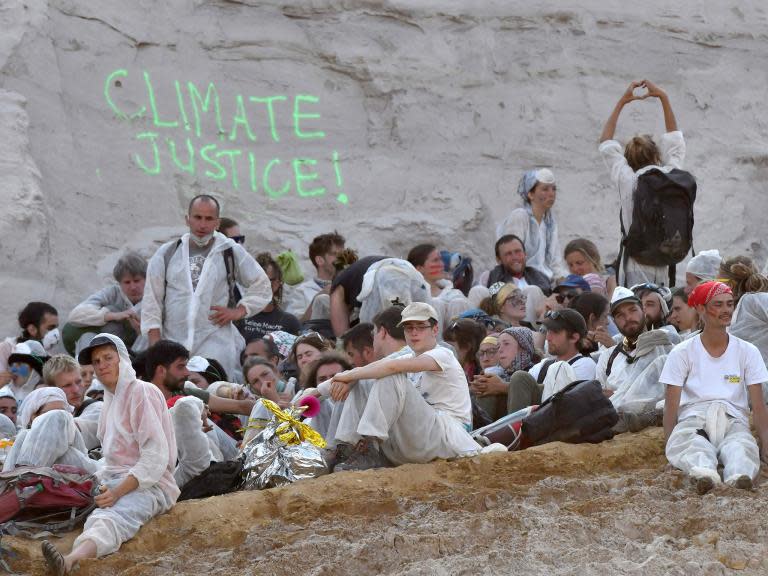 Hundreds of climate activists stormed one of Germany's biggest open-pit coal mines in a protest against fossil fuel use.Protesters broke through a police cordon on Saturday into the Garzweiler mine in the country’s Rhineland region.It came after when 40,000 students rallied for more government action against climate change on Friday in the nearby city of Aachen. "We wrote climate history this weekend," the activist group End of Story said as it halted the protest. "Our movement has never been so diverse and never been so determined." The long-planned protests began on Friday just hours after European Union leaders failed at a summit to agree on how to make the EU carbon neutral by 2050. On Saturday, some demonstrators blocked the railroad tracks used to transport coal before others broke through a police cordon to enter the mine.Protesters and police accused each other of combative behaviour in the mine and of causing injuries.Police repeatedly asked protesters to leave warning they faced life-threatening danger. Eight officers were injured in scuffles with protesters, police said. Police cut the locks the protesters had used to chain themselves to the railway tracks and then carried the protesters out one by one. Inside the mine, some protesters left voluntarily, while others were taken on buses and driven out of the mine. Police took the identities of all demonstrators before letting them go. German news agency dpa reported that activists claimed police had denied water and food to those who were temporarily detained. Police denied the allegation. The mine has been the focus of many protests in recent years because the operator, German utility company RWE, planned to cut down a forest to enlarge it. Later on Sunday, Aachen police tweeted that RWE had filed a criminal complaint against those protesters who had locked themselves to the tracks. The utility company had stopped mining during the three days of protests. Following months of climate protests by students and a sharp rise in the polls for Germany's Greens party, German Chancellor Angela Merkel recently threw her weight behind the goal of making Germany climate neutral by 2050. That would mean the country's economy no longer would add greenhouse gases to the atmosphere. Scientists say ending fossil fuel use by mid-century is a must if countries want to achieve the 2015 Paris climate accord's most ambitious goal of keeping global temperatures from rising more than 1.5C compared to pre-industrial times. AP