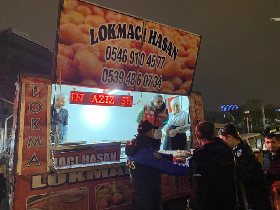 Local municipal police from the Beyoglu district handing out free Lokma (fried dough) to the public during 'Tarawih' prayers. — Picture by Shania Suha Marwan
