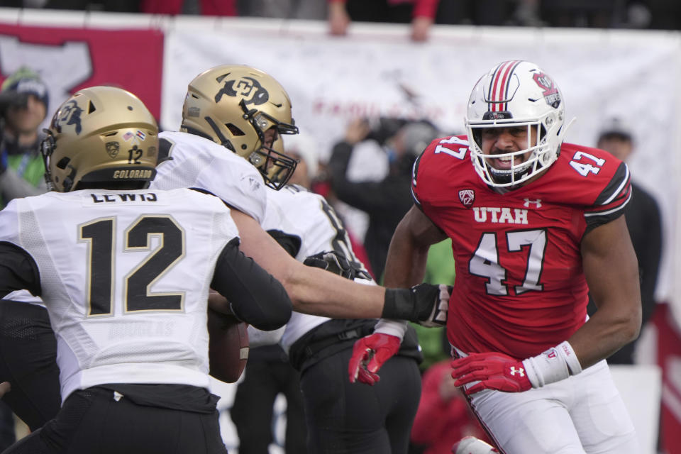 Utah defensive end Miki Suguturaga (47) applies pressure to Colorado quarterback Brendon Lewis (12) in the first half of an NCAA college football game Friday, Nov. 26, 2021, in Salt Lake City. (AP Photo/George Frey)